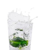 Fresh splash with lime in glass of water photo