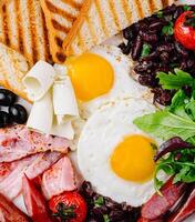 Full breakfast plate with eggs, bacon, and toast photo