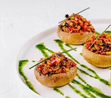 Gourmet stuffed mushrooms on elegant white plate photo