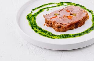 Gourmet roasted pork with herb sauce photo