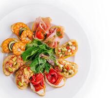 Gourmet bruschetta platter on white background photo