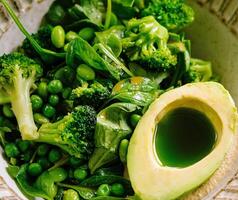 Fresh green salad with avocado and seasonal vegetables photo