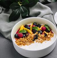 Healthy breakfast bowl with fresh fruit top view photo