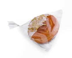 Fresh bread in plastic bag isolated photo