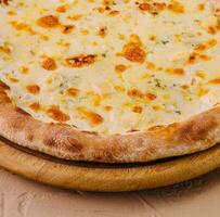 Fresh baked cheese pizza on wooden board photo