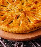 Traditional georgian khachapuri bread on ethnic tablecloth photo