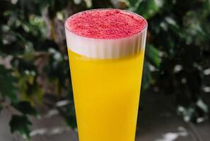 Refreshing tropical mimosa cocktail with frothy top photo