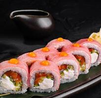 Gourmet sushi rolls on elegant black plate photo