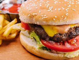 Fresh burger with french fries on wood photo