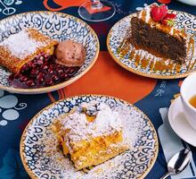 Assorted desserts on colorful tablecloth photo