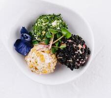 Gourmet cheese balls with herbs on elegant white dish photo