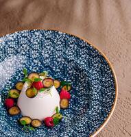 Elegant vanilla panna cotta with fresh berries photo