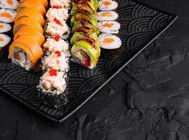 Assorted sushi platter on black background photo