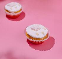 Pink delight frosted cupcakes on pink background photo