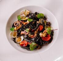 Gourmet seafood pasta with squid ink spaghetti photo