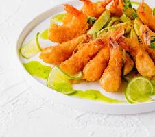 Crispy fried shrimp with lime and sauce photo