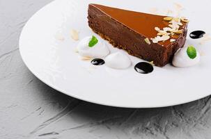 Gourmet chocolate tart on white plate photo