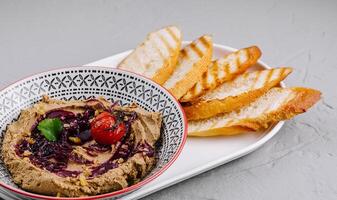 Gourmet homemade hummus with crispy bread photo