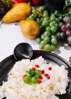 Homemade creamy rice pudding with fresh pomegranate seeds photo