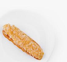 Fresh eclair on white plate photo