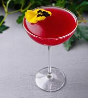 Elegant cocktail with edible flower garnish photo