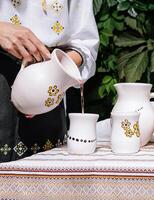 Traditional table setting with handmade ceramic pitchers photo