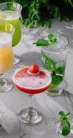 Variety of refreshing cocktails on rustic table photo