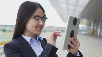 Young Asian Businesswoman with Glasses Using Digital Tablet Screen video