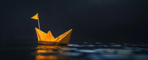 Yellow Origami Boat Floating on Water photo