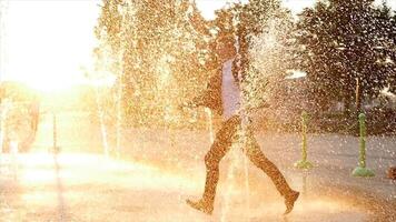 Young Happy Businessman Dancing Cheerful in Water Fountain at Sunset video