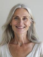 Older Woman Smiling in Front of a Window photo
