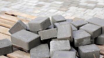 Close-up of Concrete Pavers, Close-up view of gray concrete pavers stacked on a wooden pallet, highlighting the texture and solid construction material. video