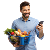 une de bonne humeur homme dans une bleu chemise détient une épicerie panier et chèques le sien téléphone intelligent dans une brillant, blanc studio png