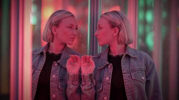 Young Blond Woman Exploring Room of Mirrors in Dreamlike Fantasy Neon Light video