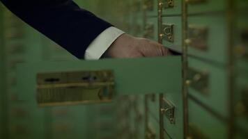 Closeup of hand in formal wear, holding key in safe with glass door video