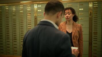 Man sharing a document with woman, both in formal wear video