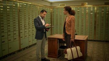 A man and a woman in formal wear standing in a room with rows of wooden lockers video