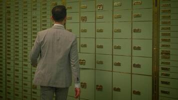 A man in a suit is by a row of lockers on a wooden wall video