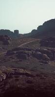 A rocky mountain with a trail going through it video