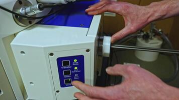 Close up of worker adjusting 3D printer at the workshop. Stock footage. Industrial background at workshop. video