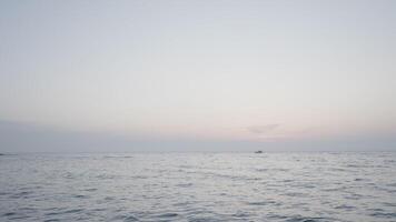 Beautiful long sea. Action. The undulating sea in the landscape against the background of a slightly misty sky, behind which ships sail in the distance. video