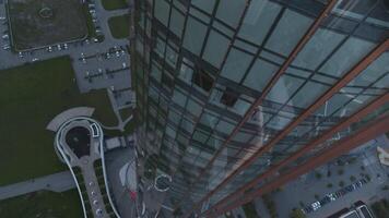 Aerial top view of a skyscraper with glass facade building. Stock footage. Glass tower, beautiful city building. video