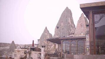 Tourist town with houses in Cappadocia. Action. Modern stylish house on background of houses in rocks. Modern restaurant for tourists on background of ancient houses in rocks and stones video