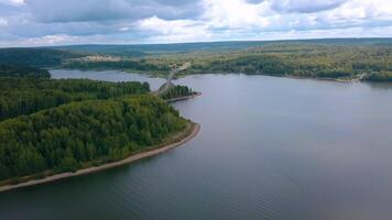 The huge Crimean bridge. Clip. A bridge passing through a long river against the background of forests and blue sky. video