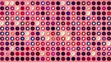 Abstract pink decorative background with rows of circles changing colors, seamless loop. Motion. Shimmering rings on bright glamourous backdrop. video