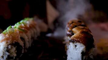 Close-up of woman's hand holding Take Sushi chopsticks and Set of delicious Japanese sushi rolls video