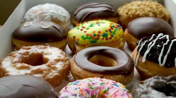 From above sweet tasty donuts with different glazing on wooden table video