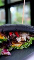 Snacks and salad with ketchup arranged on plate black bun with cuttlefish ink video