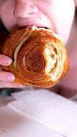 Young blonde woman with bang eating croissants at a cafe. Girl bite piece of croissant look joyful at restaurant. Cheat meal day concept. Woman is preparing with appetite to eat croissant. video