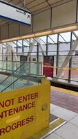 renovation of Sky Train station on Surray Central no entry exit Use same platform in both directions Be careful Do not cross the yellow line of inscription people waiting for train barrier 06.19.2023 video